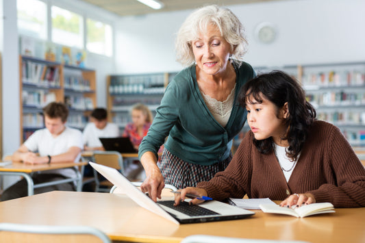 Volunteer assisting student in library